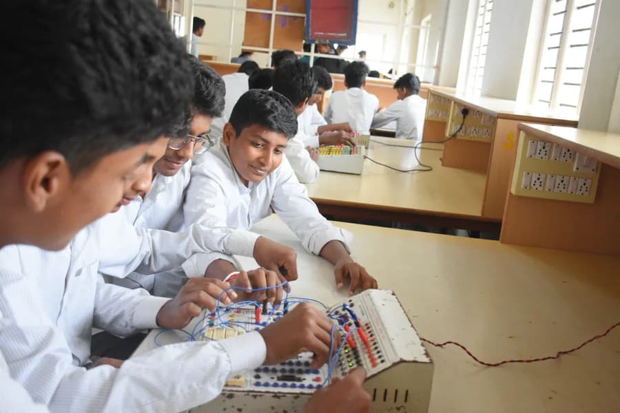 Students assembling a circuit on a breadboard in the EC lab