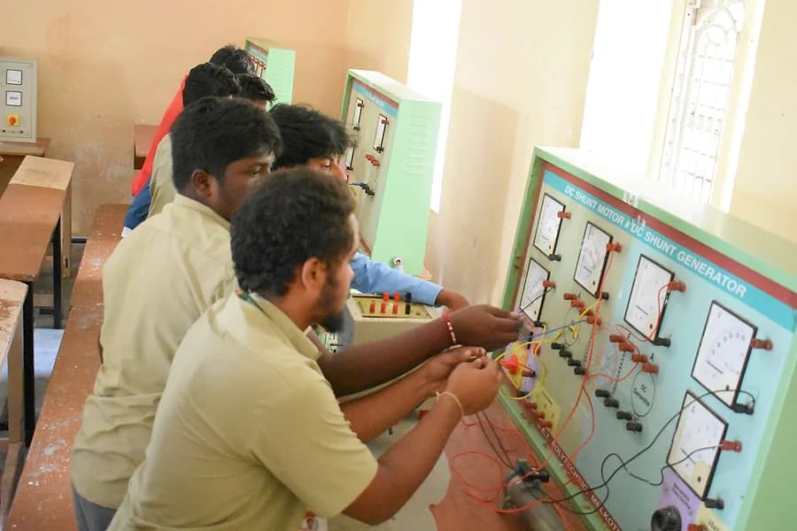 Students taking readings at an electrical panel board in the EE lab